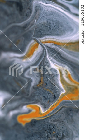 Sparkling ink wave. Marble texture. Defocused white gray orange color golden metallic glitter particles paint swirl acrylic fluid spill abstract art background. Sparkling ink wave. Marble texture. Defocused white gray orange color golden metallic glitter particles paint swirl acrylic fluid spill abstract art background. 116065102