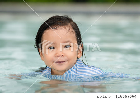 happy toddler baby float in swimming pool 116065664