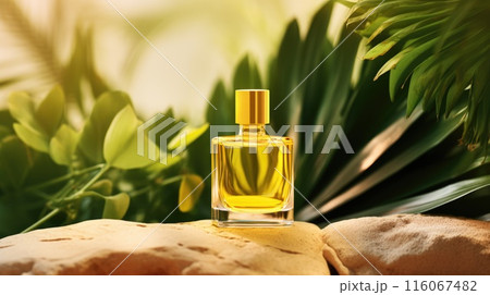 Transparent yellow glass perfume bottle mockup with plants on background. Eau de toilette. Mockup, spring flat lay. 116067482