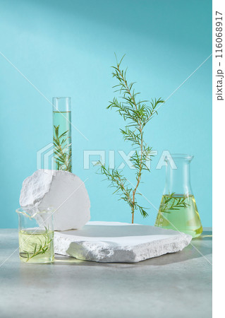 Promotion photo for beauty care products, which has tea tree ingredient such as moisturizers, cleaning or mask. Lab instruments contain tea tree extract placed around for decoration, copy space 116068917