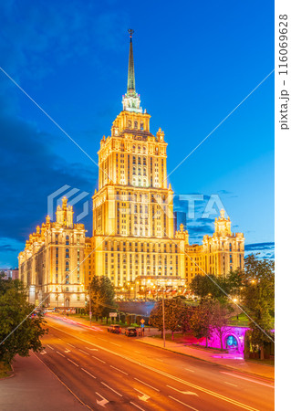 Illuminated high-rise stalinist building near river at summer night in Moscow, Russia. Historic name is Hotel Ukraina. 116069628