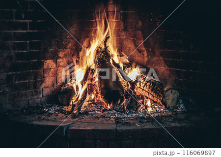 Wood burning fireplace, warm and cozy in cold weather outside the home Wood burning fireplace, warm and cozy in cold weather outside the home 116069897