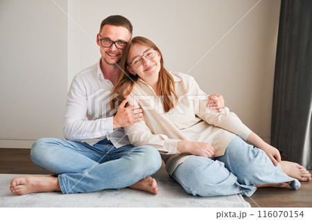 Portrait of father and teenage daughter hugging each other at home. Cute moment of dad and child in glasses showing their love to each other. Lovely spending time with family. Portrait of father and teenage daughter hugging each other at home. Cute moment of dad and child in glasses showing their love to each other. Lovely spending time with family. 116070154