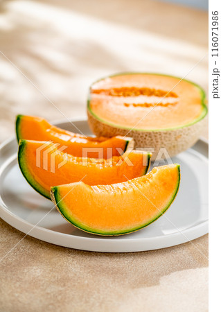 A sweet melon on a plate. 116071986