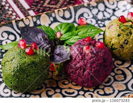 Colorful trio of gourmet vegan balls on decorative plate 116073283