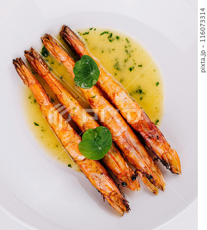 Grilled shrimp with sauce on white plate Grilled shrimp with sauce on white plate 116073314