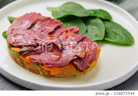Gourmet beef tenderloin on toast with spinach Gourmet beef tenderloin on toast with spinach 116073344