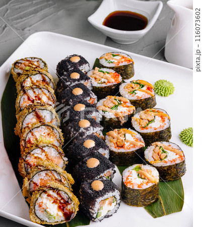 Assorted sushi rolls platter with dipping sauce 116073602