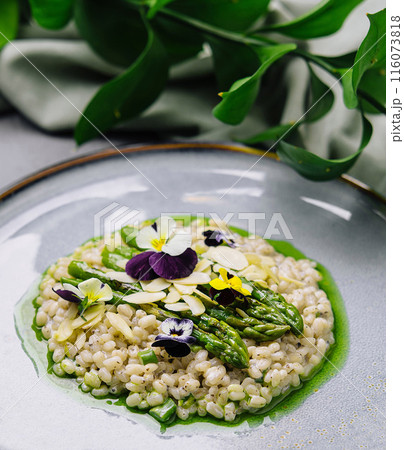 Gourmet risotto with asparagus and edible flowers Gourmet risotto with asparagus and edible flowers 116073818
