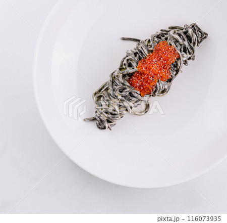 Gourmet black pasta with red caviar 116073935