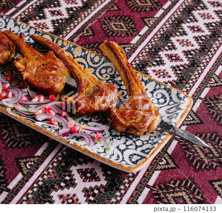 Spicy grilled lamb chops on ornate plate 116074133