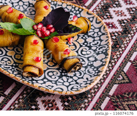 Traditional stuffed grape leaves on ornate plate 116074176