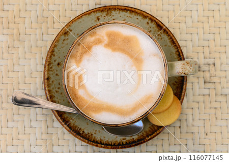 Cup of latte coffee and spoon on gray counter 2 Cup of latte coffee and spoon on gray counter 2 116077145