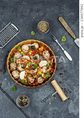 Edible stuffed grape snails in baking dish 116077942