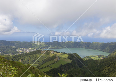 A beautiful view of a lake and mountains with a clear blue sky 116082209