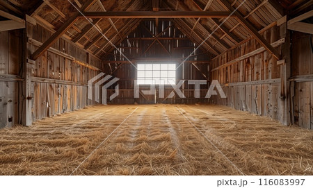 Old empty barn interior with with hay on the floor, sunlight shining through the window. 116083997