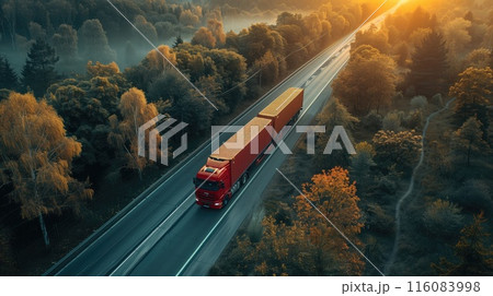 A red truck driving down a highway surrounded by trees 116083998