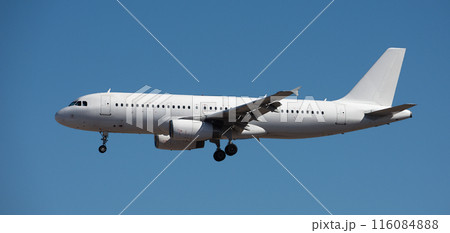 The plane lands.Airplane, passengers flying in the blue sky, preparing to land at the airport 116084888