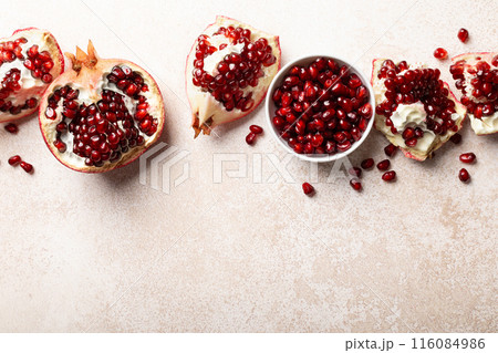 Pomegranate. Fresh organic juicy pomegranate fruit pieces. Pomegranate seeds, grains, top view. 116084986