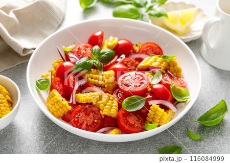 Tomato and corn salad with fresh basil, onion, dressed with olive oil. Mexican food, tomato corn salad Esquites 116084999