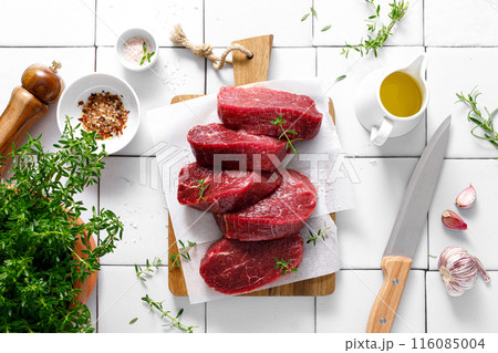 Beef. Raw beef tenderloin meat, beef steaks with ingredients for cooking. Top view Beef. Raw beef tenderloin meat, beef steaks with ingredients for cooking. Top view 116085004