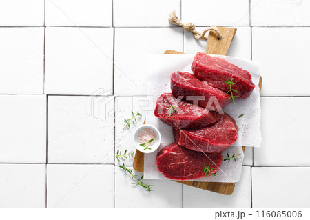 Beef. Raw beef tenderloin meat, beef steaks with ingredients for cooking. Top view Beef. Raw beef tenderloin meat, beef steaks with ingredients for cooking. Top view 116085006