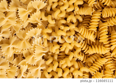 Background of raw pasta close-up. Italian raw pasta mockup, top view Background of raw pasta close-up. Italian raw pasta mockup, top view 116085111