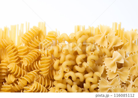 Variety of types and shapes of dry Italian pasta on a white background, top view 116085112