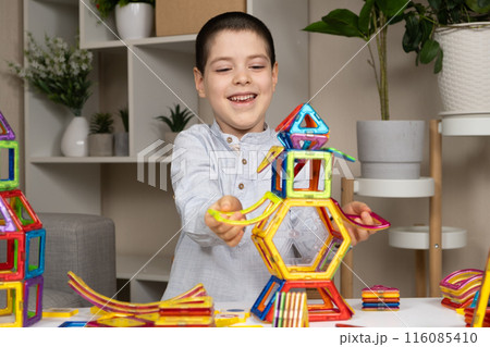 A child plays with a magnetic construction set. Interesting educational toys. 116085410
