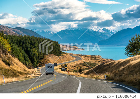 Road trip of Mt Cook over winding road with motorhome driving on sunny day at Peters lookout, New Zealand 116086414