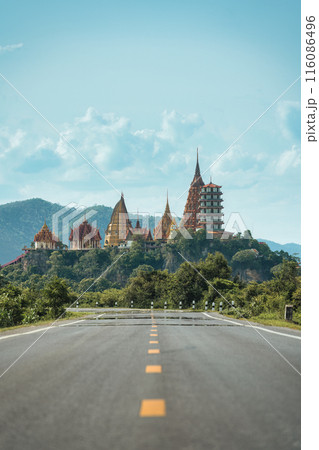 Rural road straight to Wat Tham Sua Temple on hill in Kanchanaburi Rural road straight to Wat Tham Sua Temple on hill in Kanchanaburi 116086496