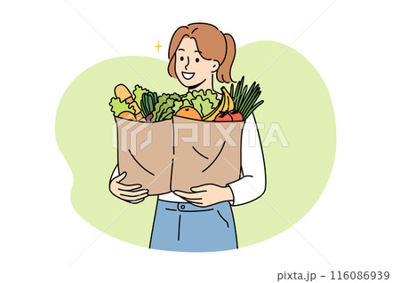 Vegan woman proudly carries paper bags with natural vegetables and fruits bought at farmers fair 116086939
