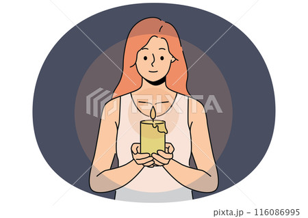 Woman with candle in hands looks at fire, performing religious ritual or seance. Woman with candle in hands looks at fire, performing religious ritual or seance. 116086995