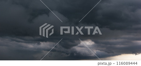 Bad or night weather sky and environment.The dark sky with heavy clouds converging and a hurricane storm before the rain. carbon dioxide emissions, greenhouse effect, global warming, climate change 116089444