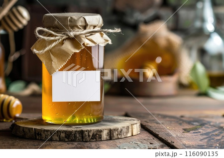 Organic Honey Jar on Rustic Wooden Table with Blank Label 116090135