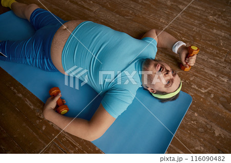 Funny overweight man feeling tired after slimming sports workout Funny overweight man feeling tired after slimming sports workout 116090482