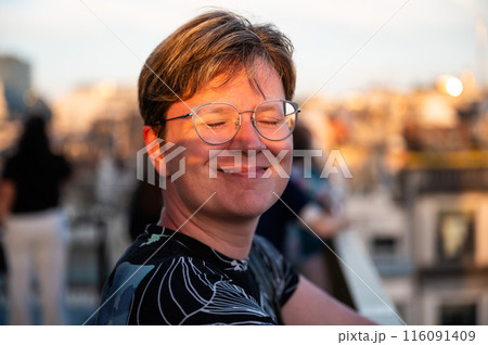 Portrait of a happy 38 yo white woman eyes closed, during golden hour, Belgium 116091409