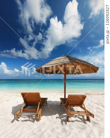 Beach chairs and umbrella on a white sandy beach. 116092827