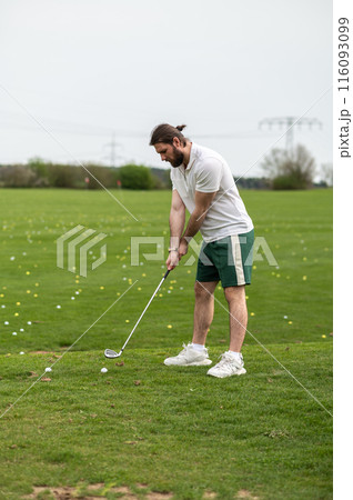 Man with golf ball on lawn for game enjoying match and competition on golfing course 116093099