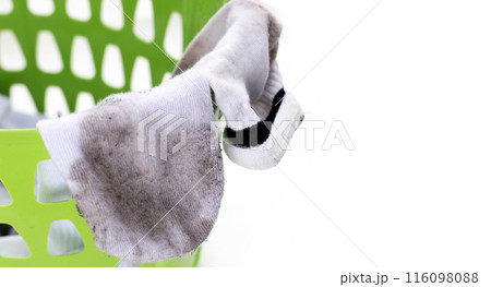 Dirty white socks in laundry basket Dirty white socks in laundry basket 116098088