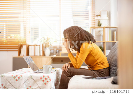 A stressed, unhappy Black woman is working from home, worried about her job, facing problems. A stressed, unhappy Black woman is working from home, worried about her job, facing problems. 116101715