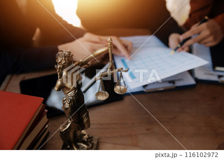Lawyer, legal advisor, businessman brainstorming information on agreement details Business contracts in legal processing books for accuracy in contract documents. joint financial investment. 116102972