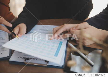 Lawyer, legal advisor, businessman brainstorming information on agreement details Business contracts in legal processing books for accuracy in contract documents. joint financial investment. 116102973