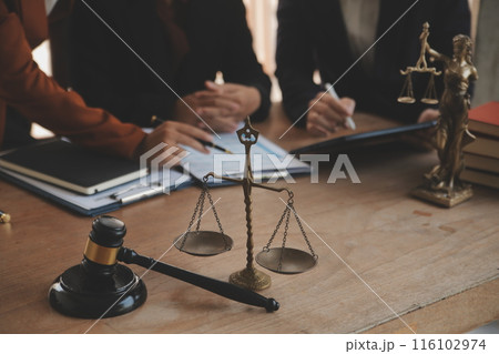 Lawyer, legal advisor, businessman brainstorming information on agreement details Business contracts in legal processing books for accuracy in contract documents. joint financial investment. 116102974