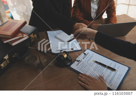 concept of justice and law A male judge in the courtroom on a wooden table and a male counselor or lawyer working in the office. Law, advice and justice concepts. concept of justice and law A male judge in the courtroom on a wooden table and a male counselor or lawyer working in the office. Law, advice and justice concepts. 116103007