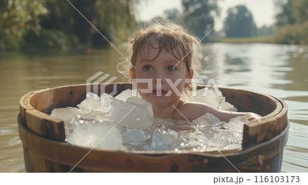 Child in Refreshing Ice Bath by the River 116103173