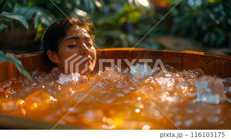 Woman Relaxing in Tranquil Ice Bath in Tropical Garden Woman Relaxing in Tranquil Ice Bath in Tropical Garden 116103175