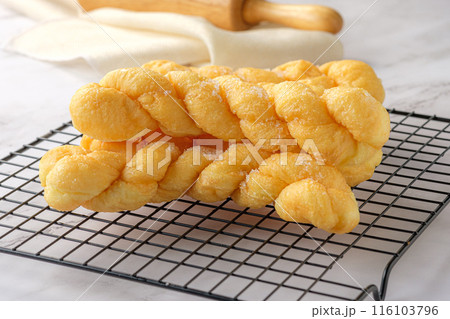 Close-up Glazed Twisted Donut on Cooling rack. 116103796