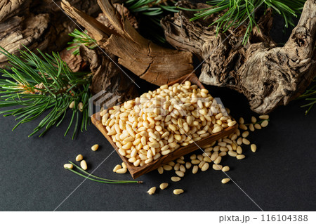 Peeled pine nuts with cedar dried snags and green branches. Peeled pine nuts with cedar dried snags and green branches. 116104388