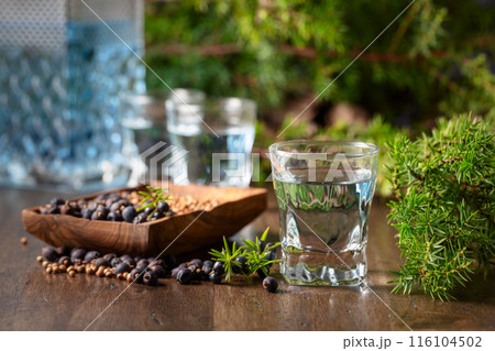 Gin with ingredients on an old wooden table. 116104502